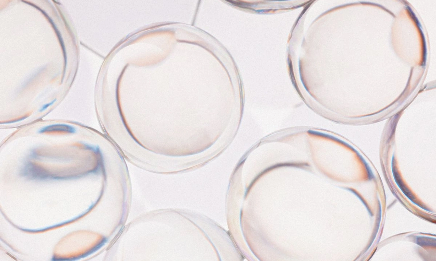 Close-up of skin peptides skincare ingredients in clear gel capsules, abstract macro view